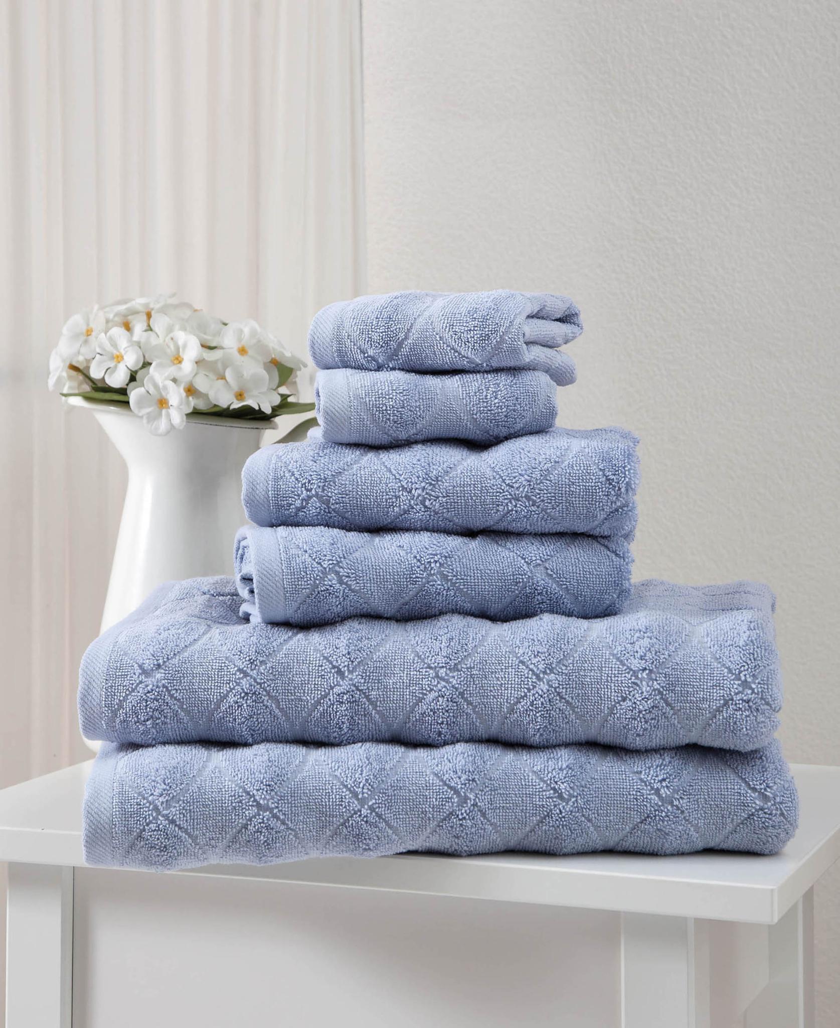 Folded blue geometric Turkish cotton towel set, stacked in three layers