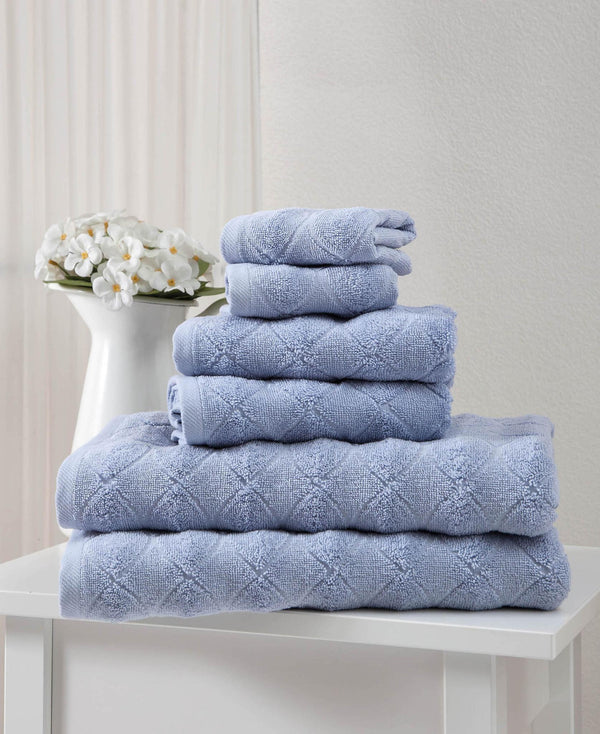 Folded blue geometric Turkish cotton towel set, stacked in three layers