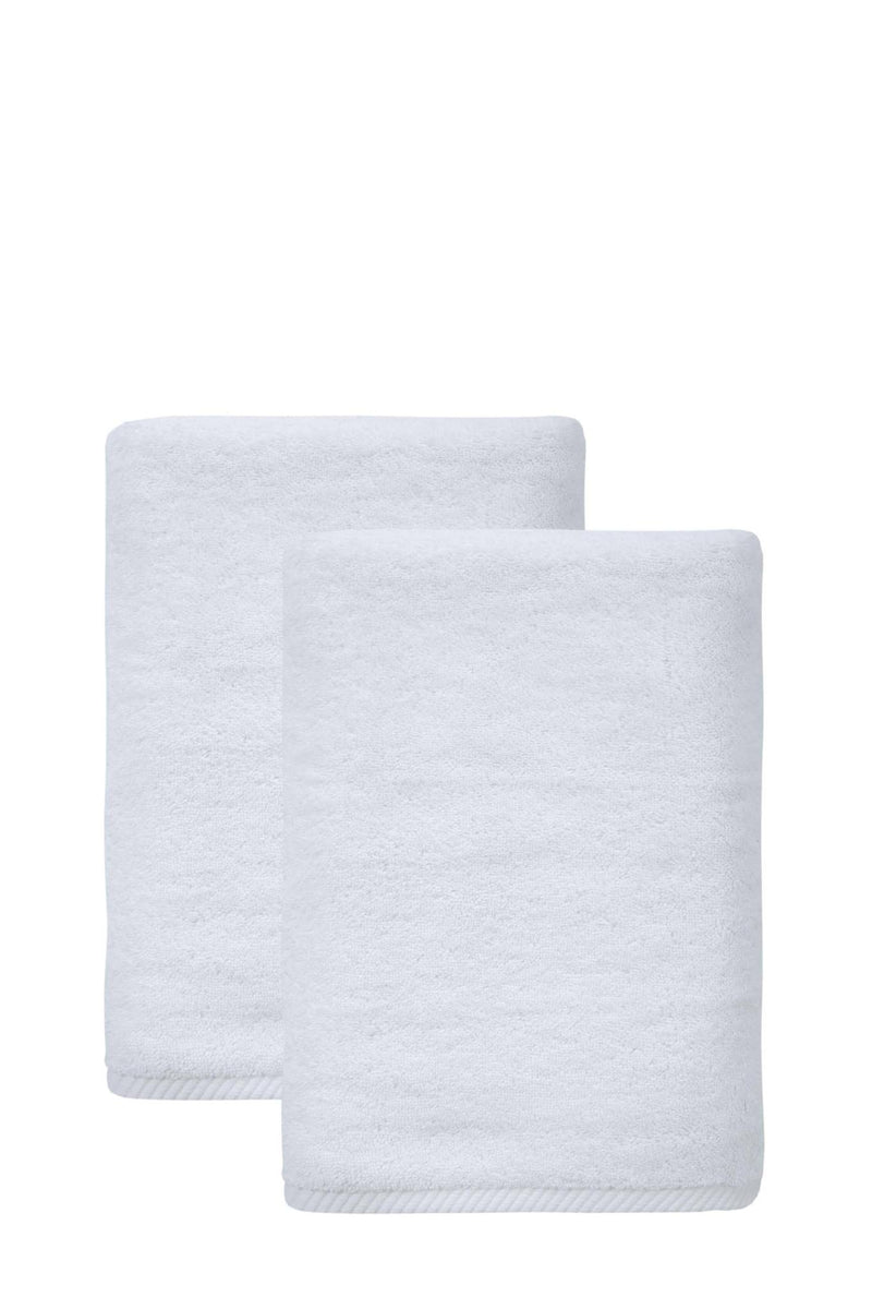 Set of two white bath towels, Turkish cotton, neatly folded and stacked