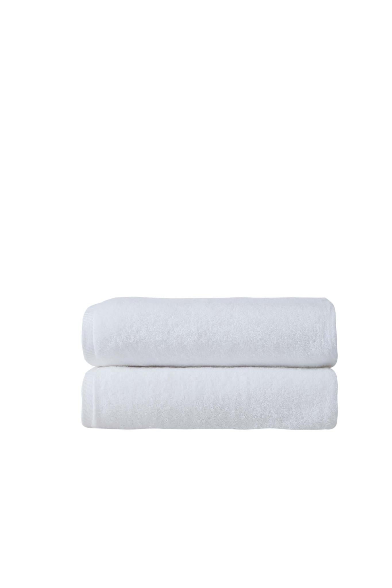 Two white Turkish cotton bath towels, stacked folded with plush texture
