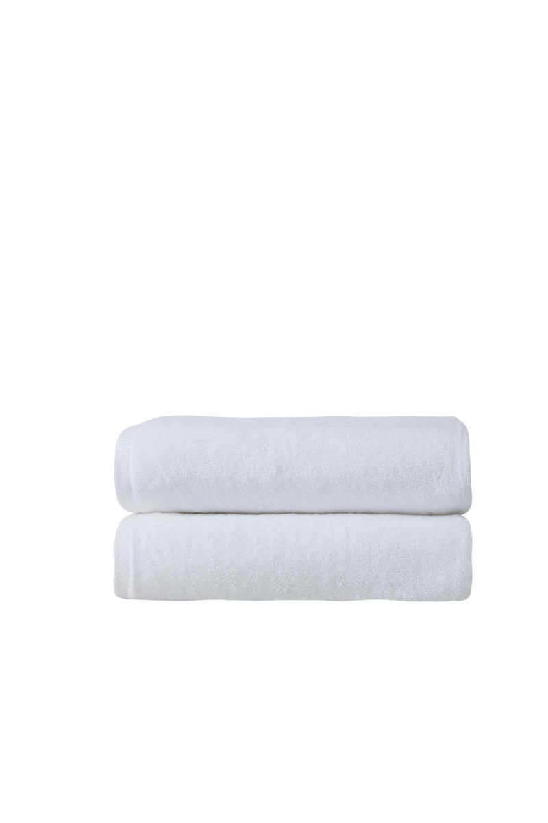 Two white Turkish cotton bath towels, stacked folded with plush texture