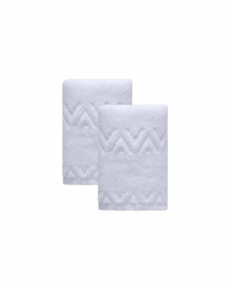 Set of two white hand towels with geometric chevron zigzag pattern, overlapping folds