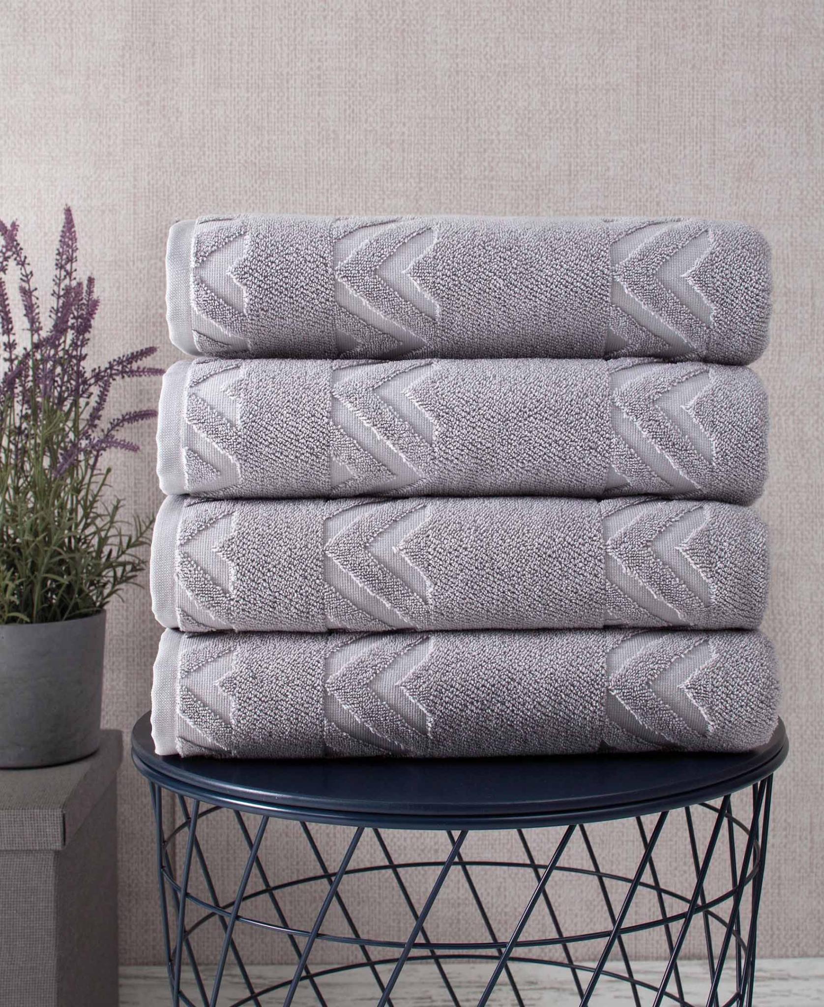 Light gray geometric Turkish cotton bath towels, four-pack, neatly folded stack