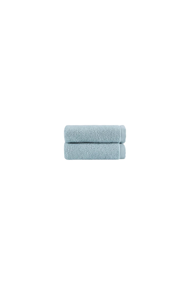 Set of two light blue hand towels, folded with soft textured terry surface.