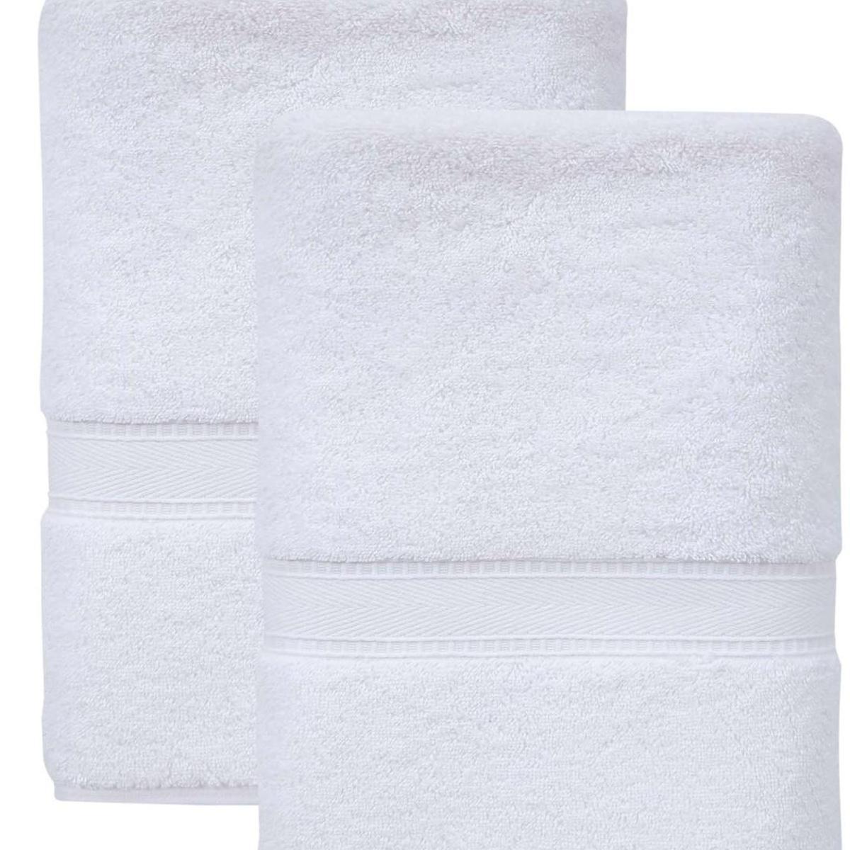 Set of two white Turkish cotton bath towels, folded with stitched border and banded edges