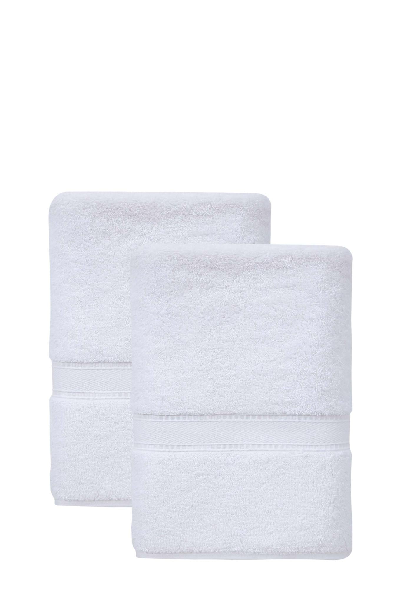 Set of two white Turkish cotton bath towels, neatly folded with matching stitched bands