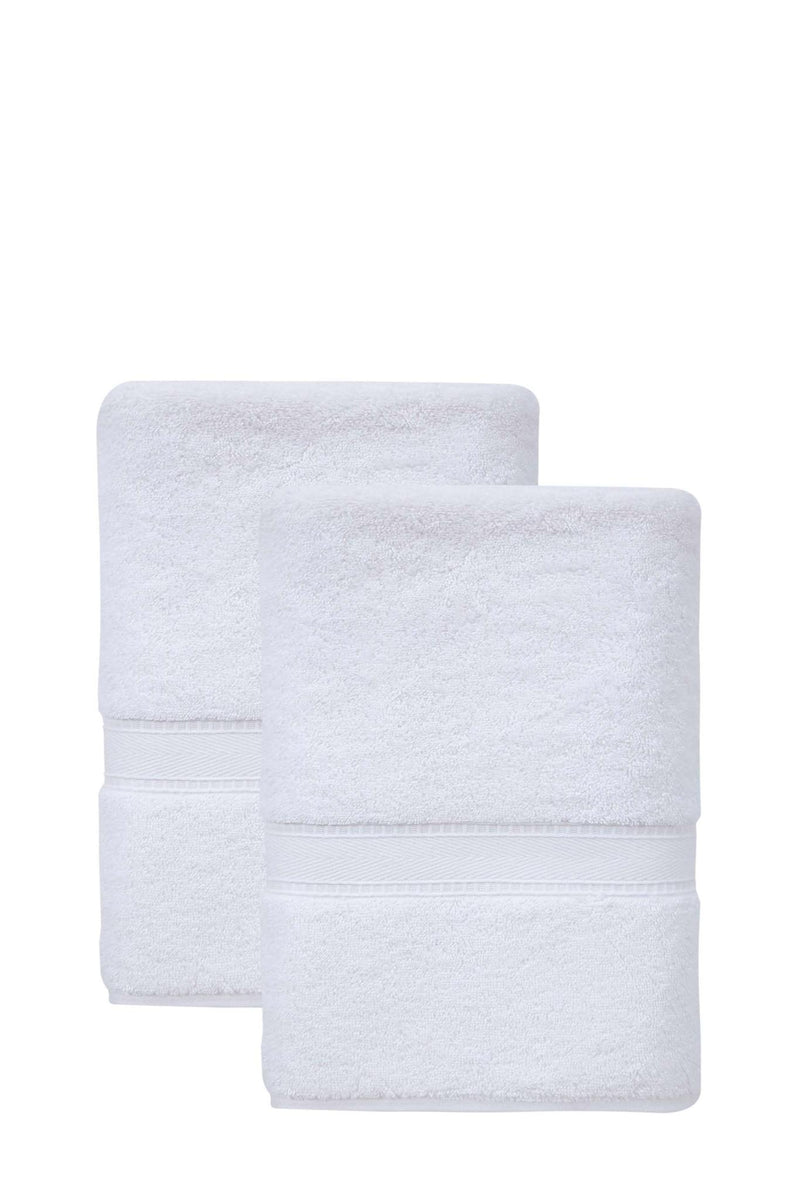 Set of two white Turkish cotton bath towels, neatly folded with matching stitched bands