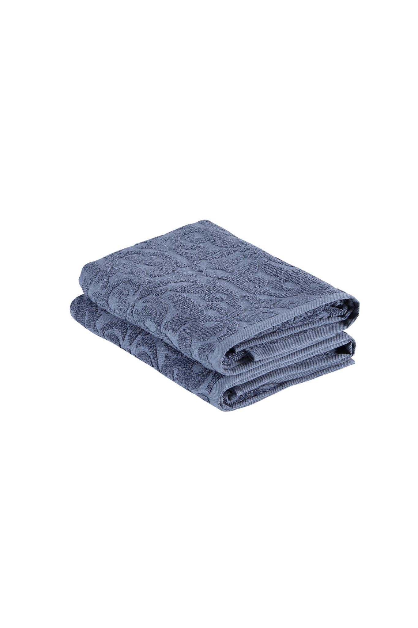 Set of two navy floral Turkish cotton bath towels, folded with raised jacquard texture