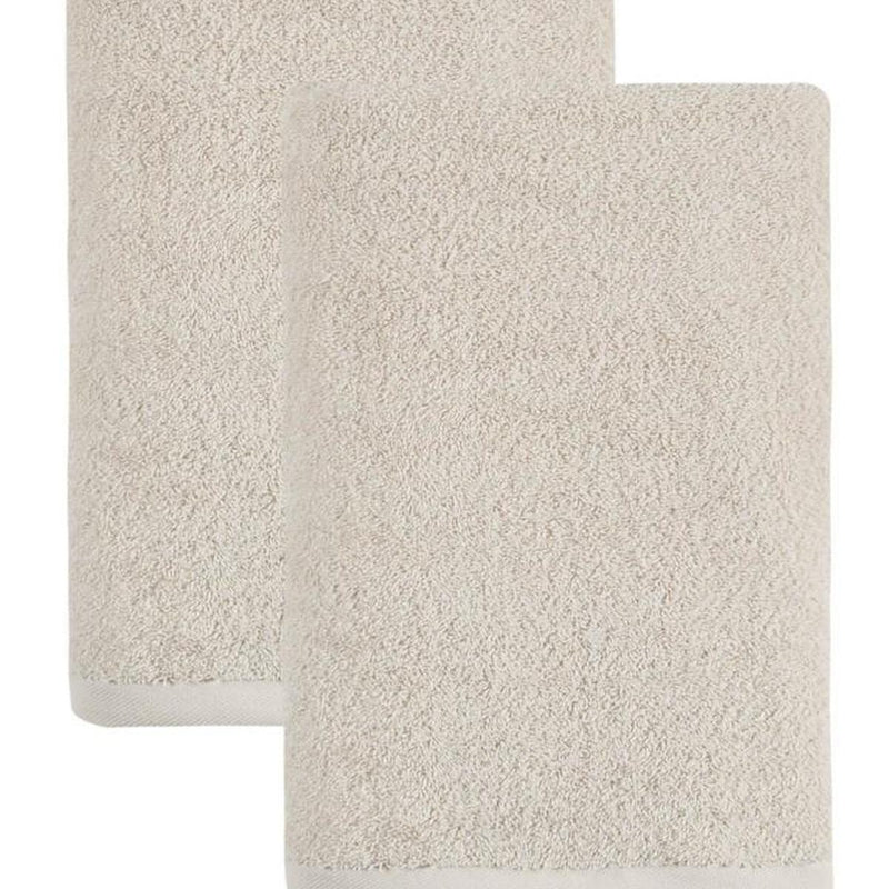 Beige Turkish cotton bath towel pair, close-up of folded textured fabric
