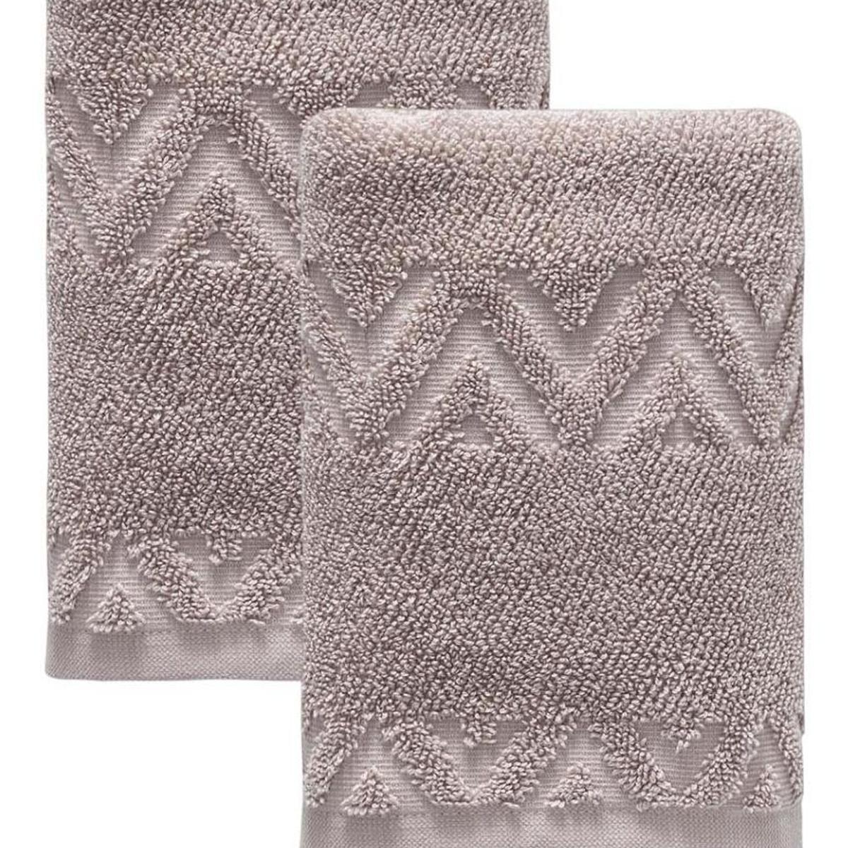 Taupe Turkish cotton hand towels with raised geometric chevron zigzag texture, close-up