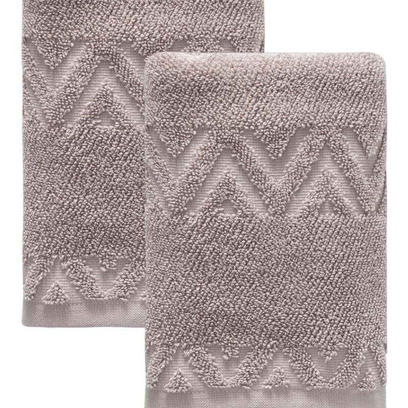Taupe Turkish cotton hand towels with raised geometric chevron zigzag texture, close-up