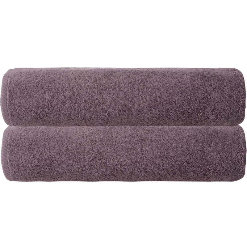 Purple bath sheets, two stacked folded towels with plush terry pile.