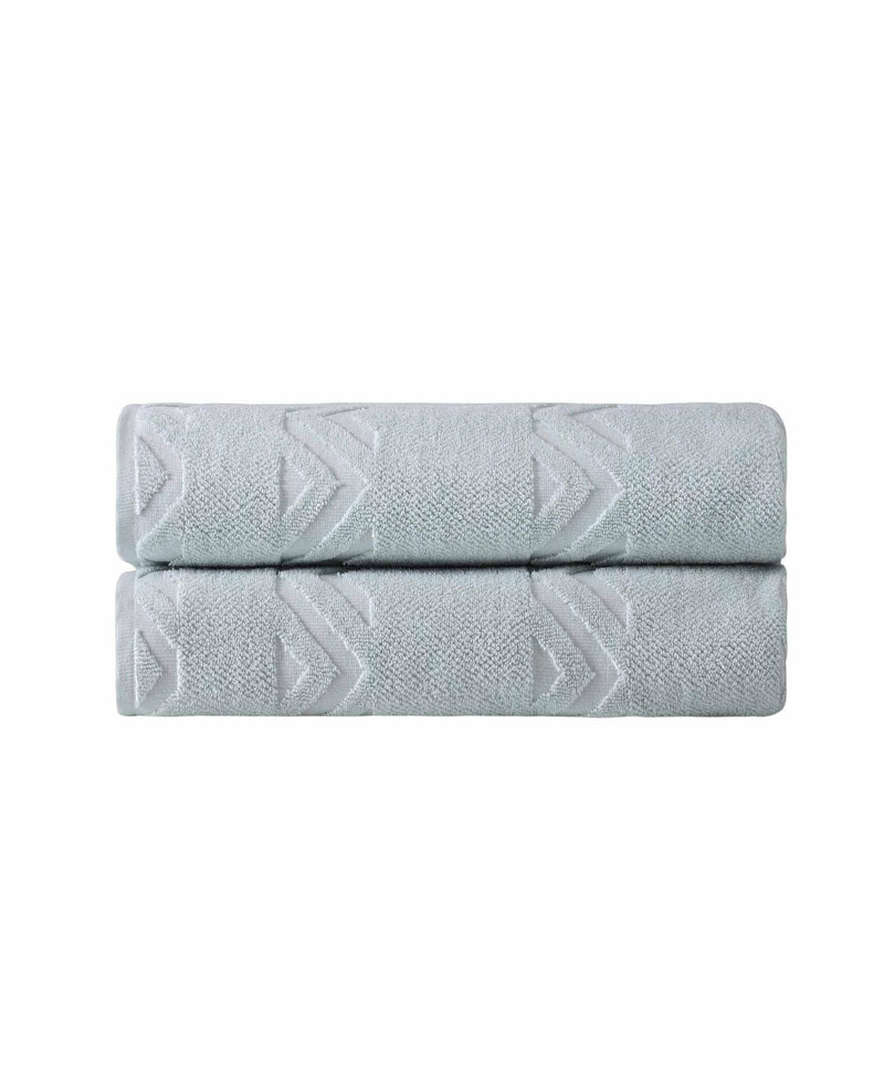Aqua bath sheet folded with embossed chevron geometric pattern