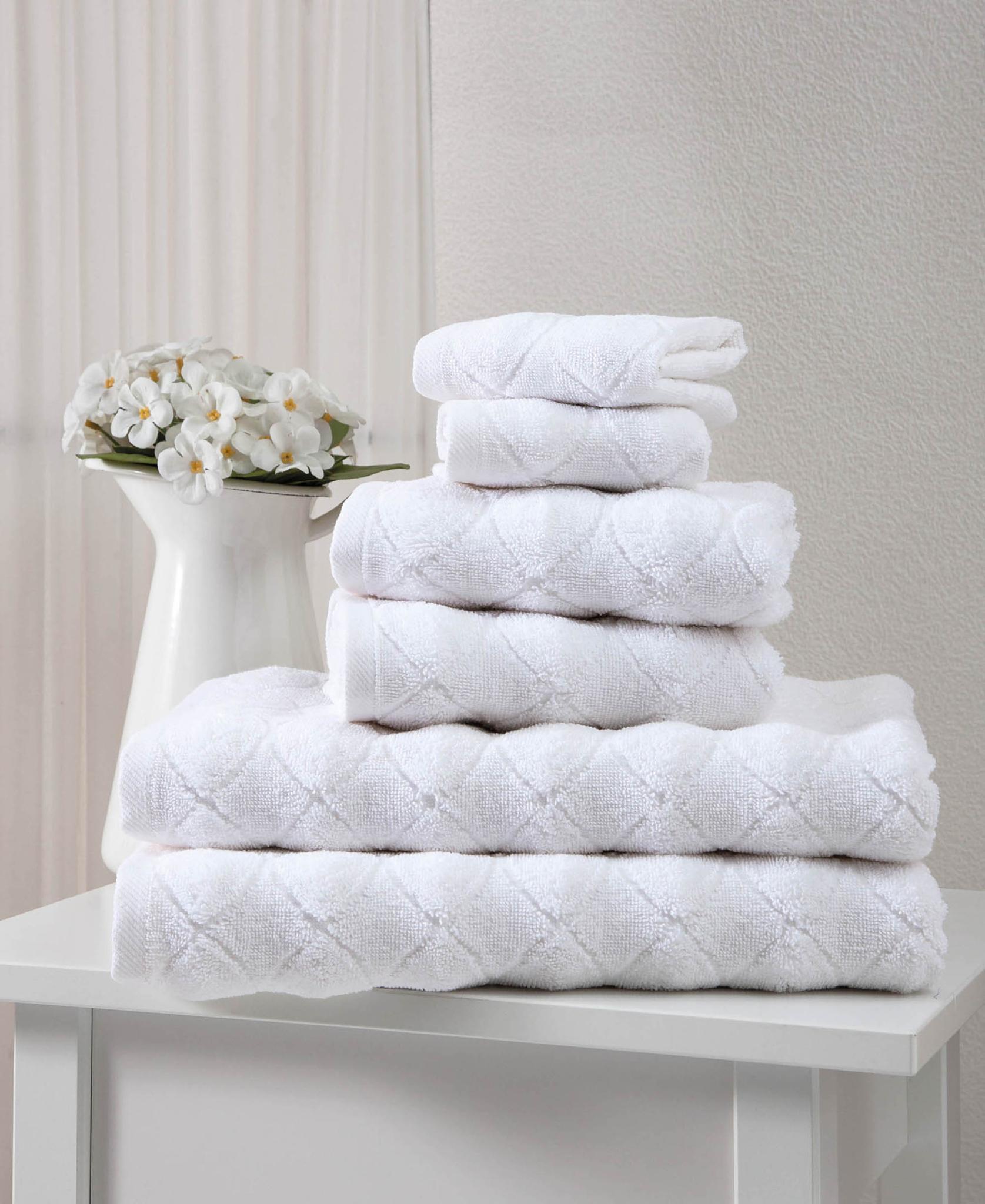 White Turkish cotton towel set with geometric pattern, stacked