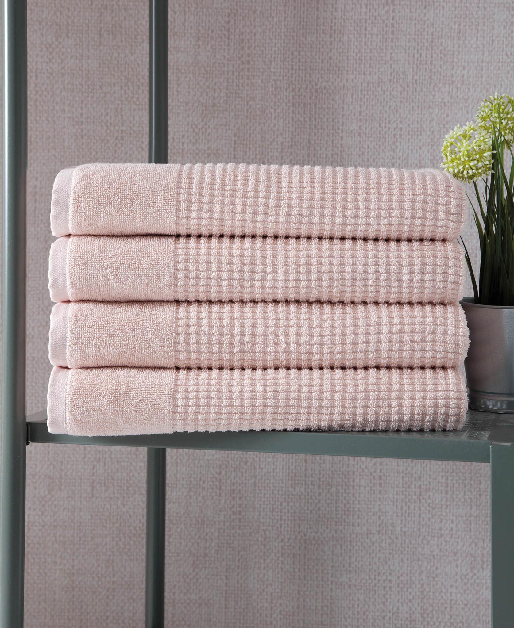 Set of four pink polka dot Turkish cotton bath towels, folded stack