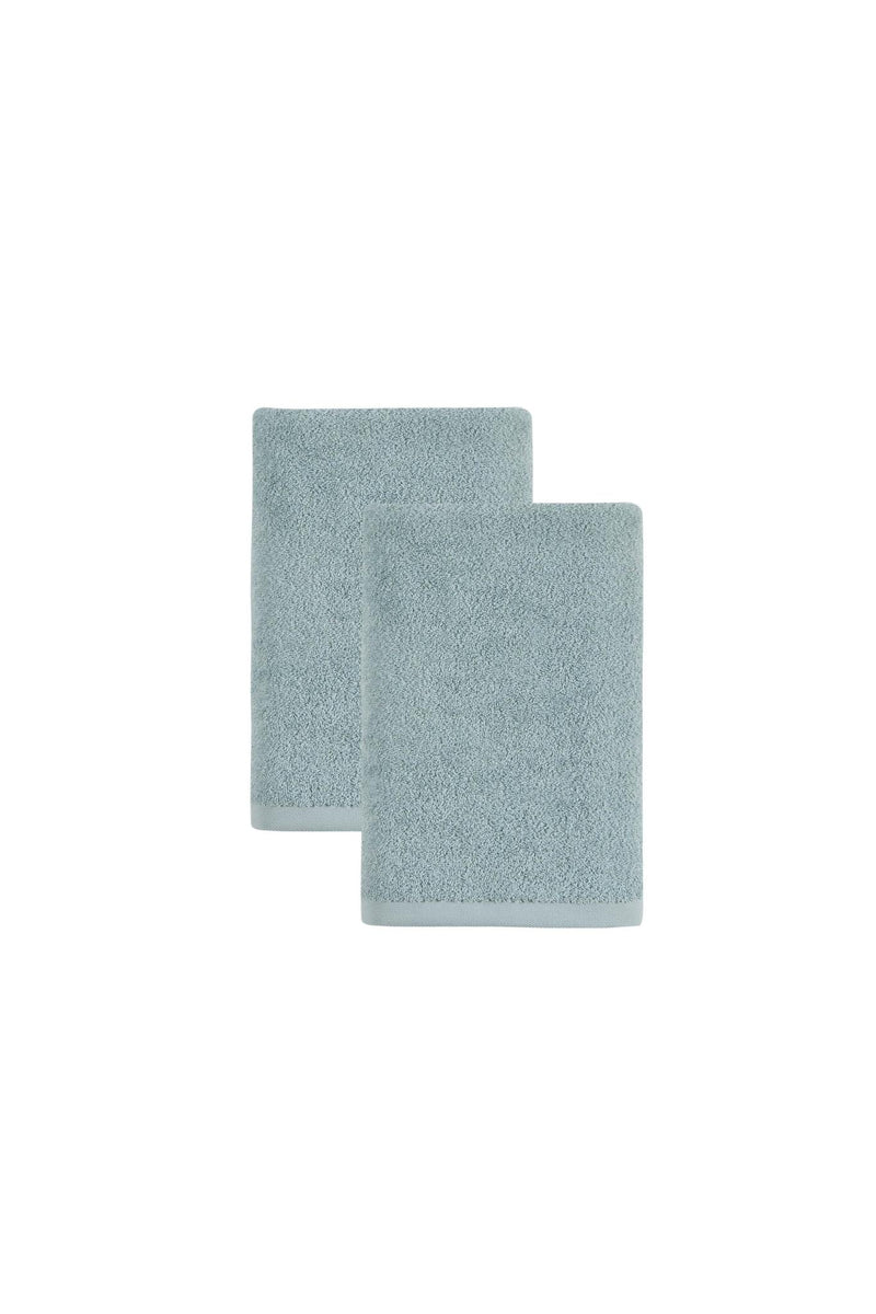 Set of two teal bath towels, folded with one standing