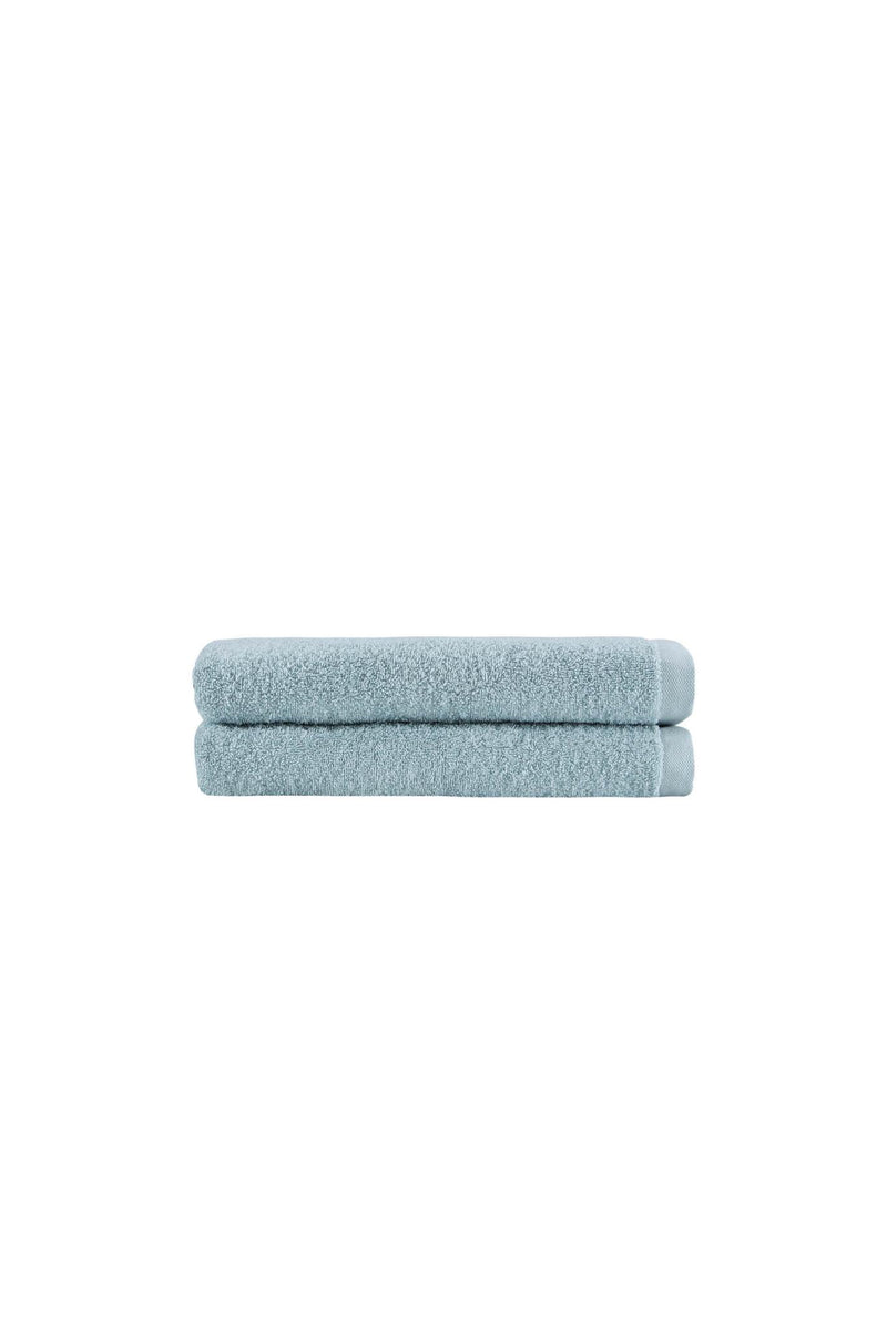 Set of two teal bath towels, neatly rolled