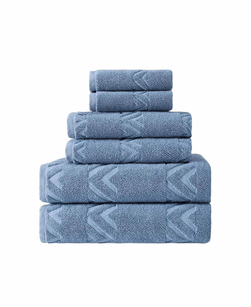 Folded blue towel set stack with raised geometric chevron pattern