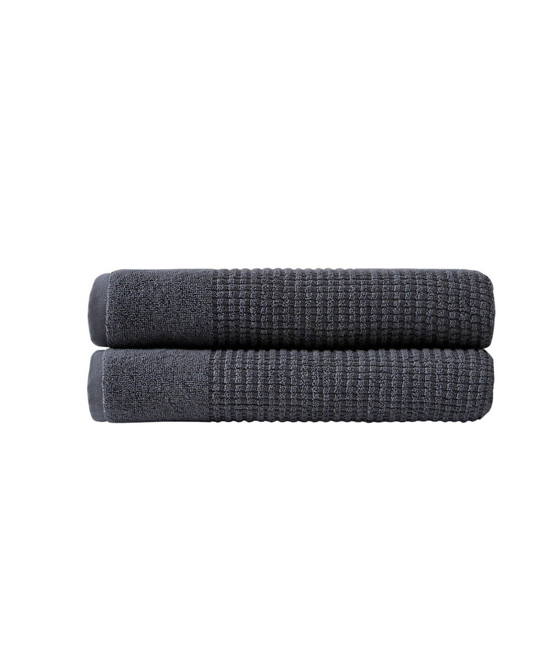 Set of two dark gray bath towels with textured waffle weave, stacked.