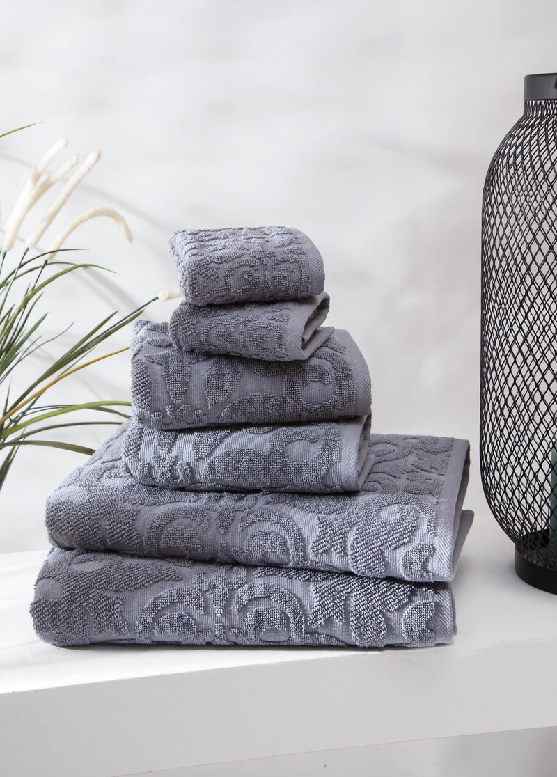 Light gray Turkish cotton towel set, folded stack with floral pattern on towels