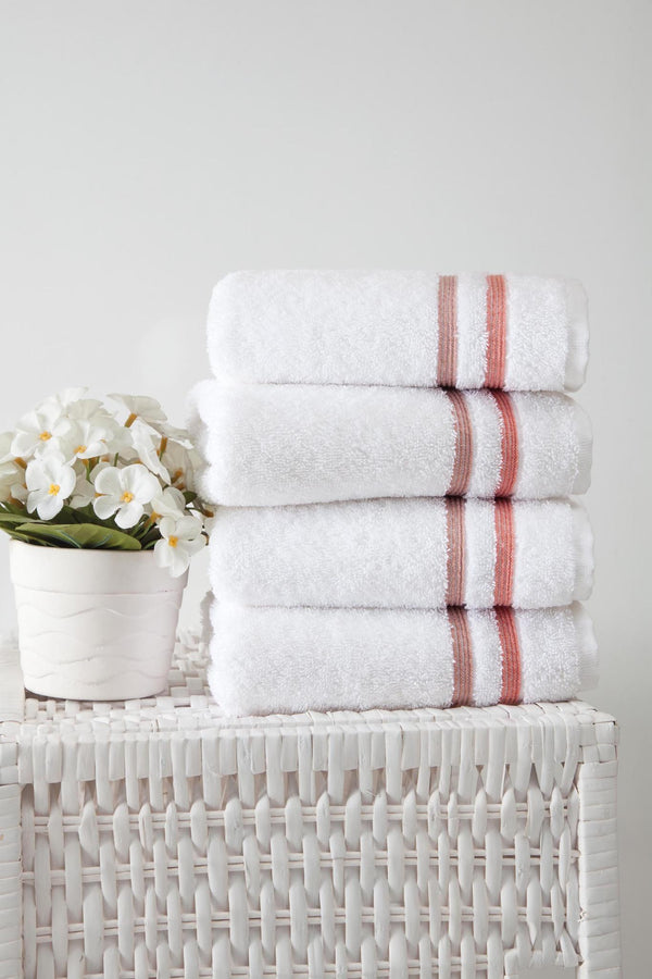 Folded white Turkish cotton hand towel set with terracotta stripe trim