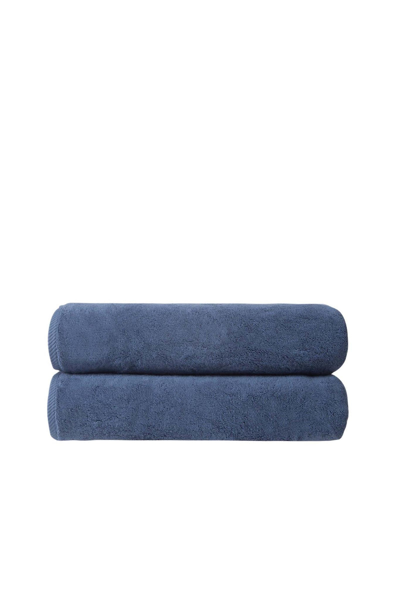 Two navy Turkish cotton bath towels, 27x54 in, rolled and stacked.