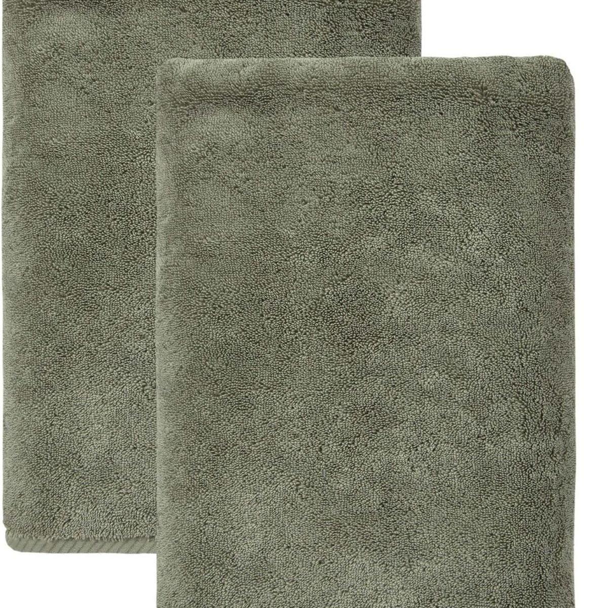 Set of two green Turkish cotton bath towels, close-up of folded towels