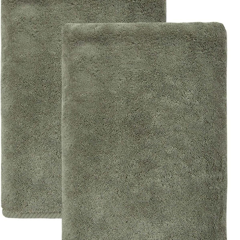 Set of two green Turkish cotton bath towels, close-up of folded towels