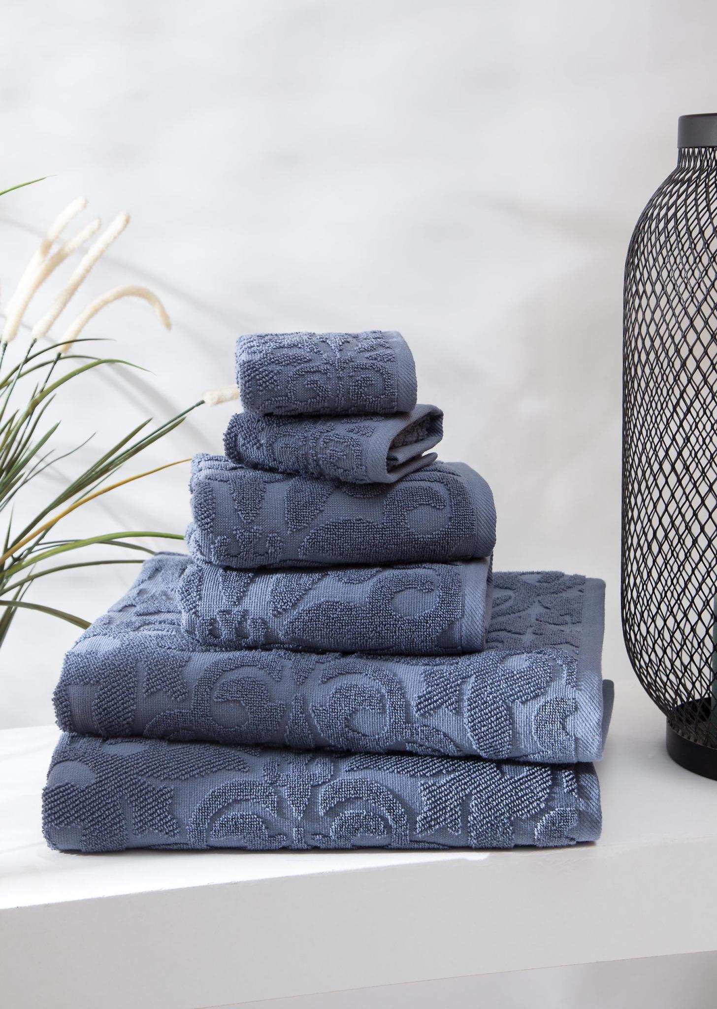 Blue Turkish cotton towel set, stacked with textured floral jacquard pattern