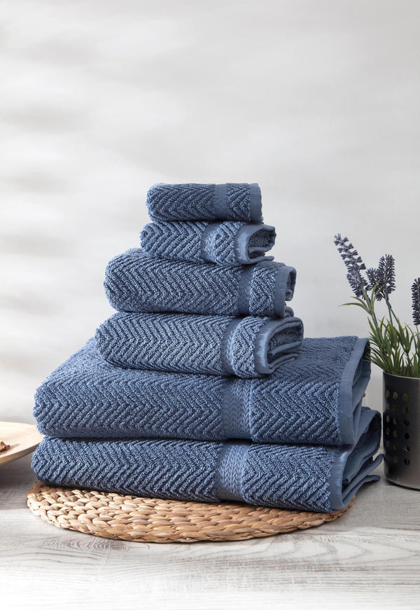 Set of six navy chevron Turkish cotton towels, neatly folded