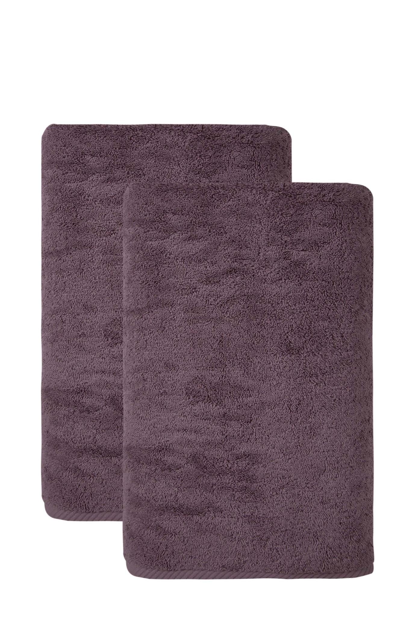 Two purple bath towels, one folded in front of the other