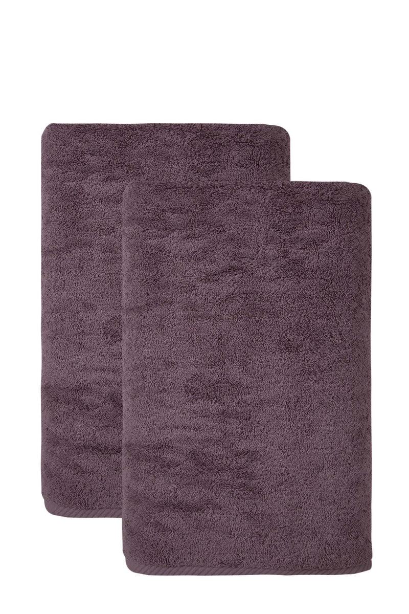 Two purple bath towels, one folded in front of the other