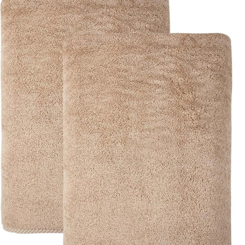 Set of two beige Turkish cotton bath towels, close-up of textured loop pile