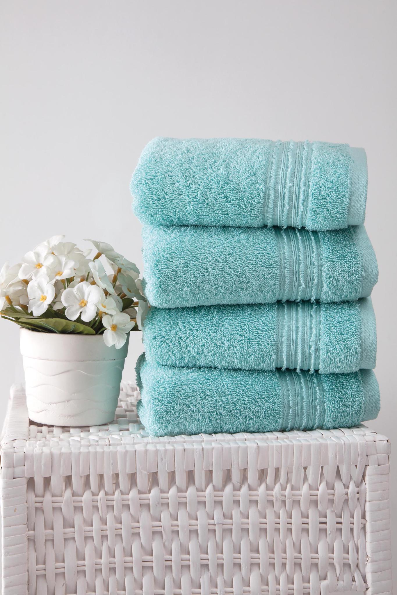 Stack of aqua Turkish cotton hand towels, 16x30 in, folded with textured loop weave
