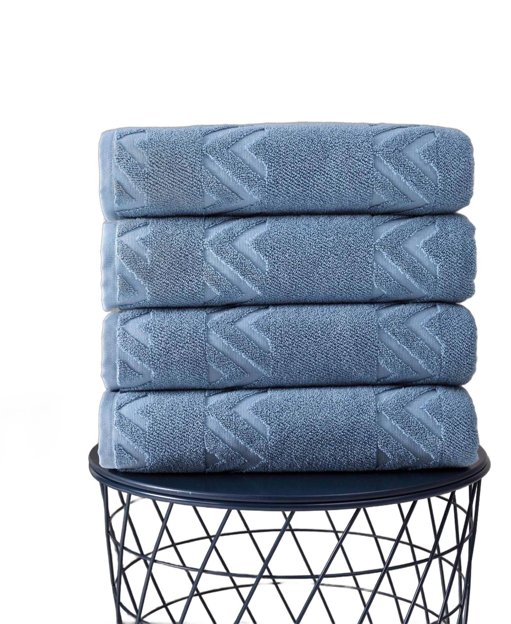 Blue Turkish cotton bath towels, geometric border pattern, folded stack