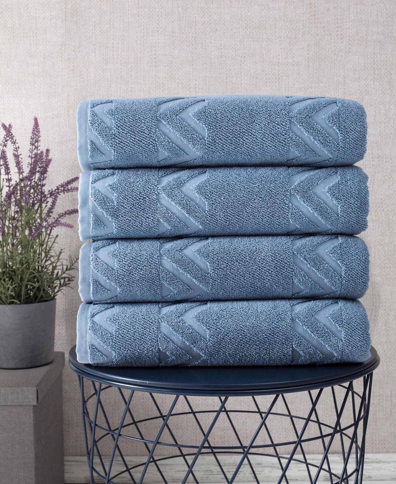 Blue Turkish cotton bath towels with chevron-like geometric weave, folded in basket
