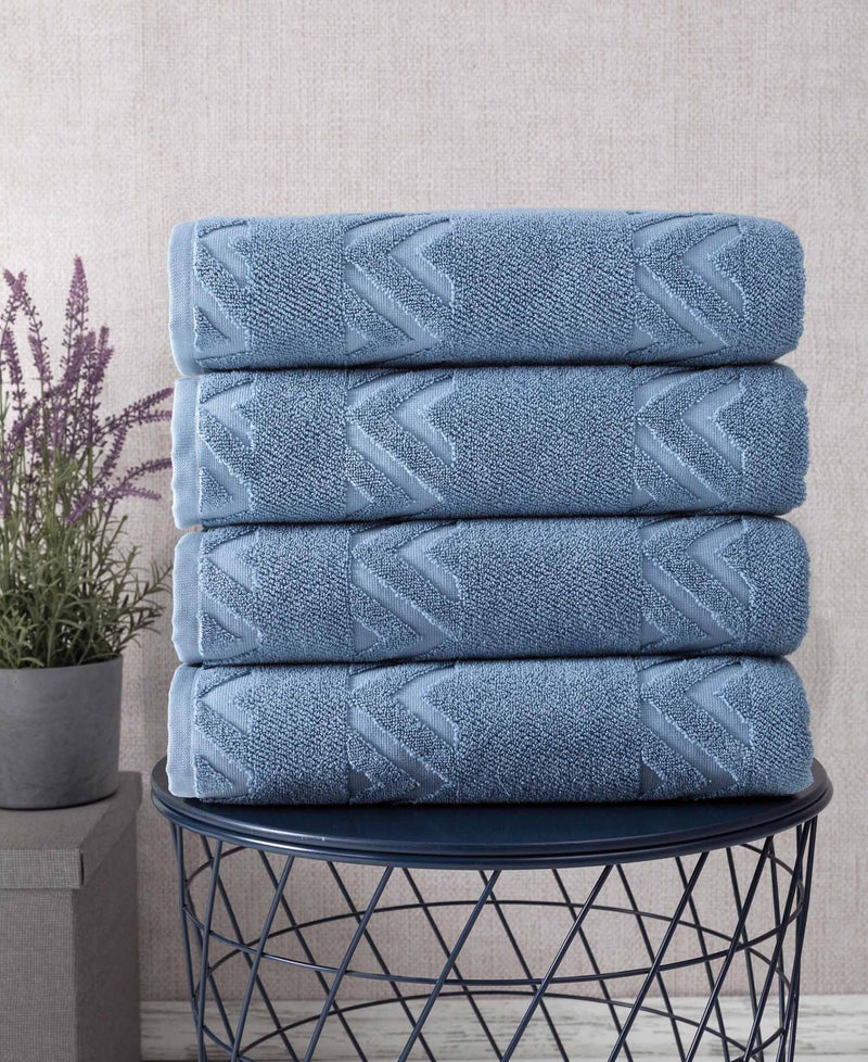 Blue Turkish cotton bath towels with chevron-like geometric weave, folded in basket