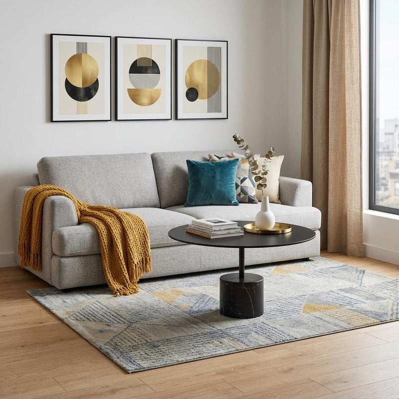 Black round coffee table on a faux marble pedestal base