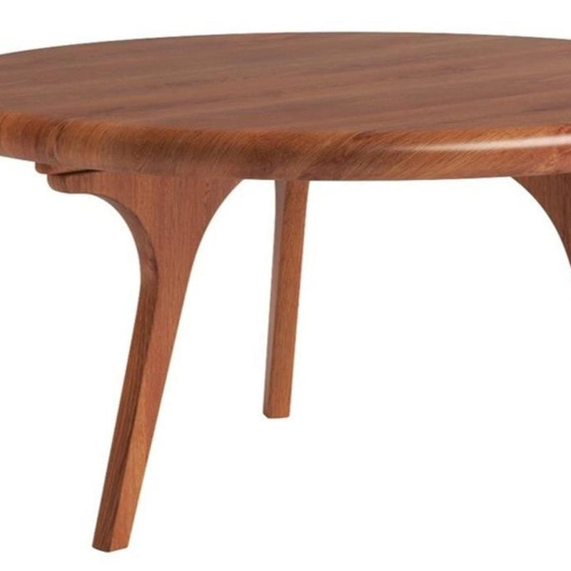 Walnut round coffee table leg detail with curved apron and smooth wood finish