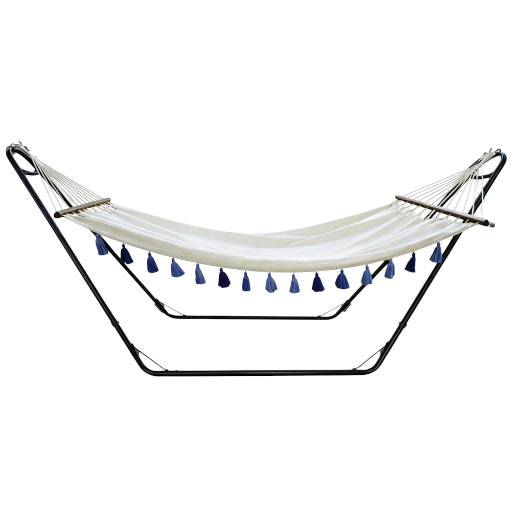 Ivory fabric hammock with black spreader bar and blue tassels, single hammock