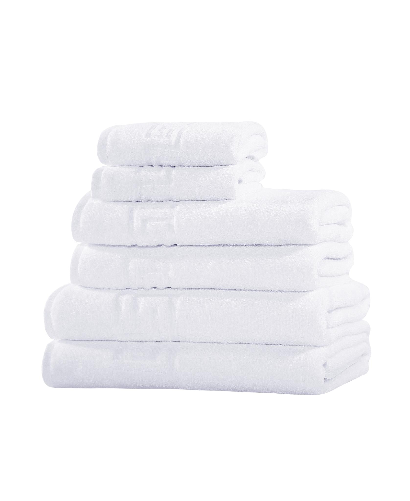 Set of six white Turkish cotton towels, folded stack with visible side edges