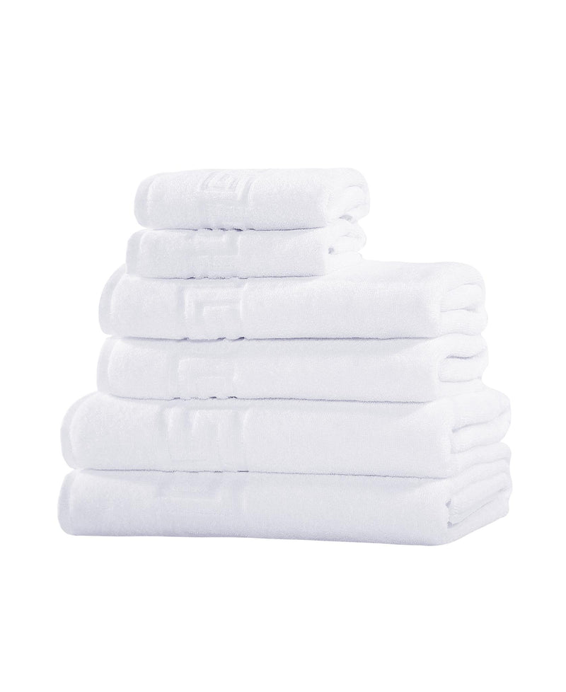 Set of six white Turkish cotton towels, folded stack with visible side edges