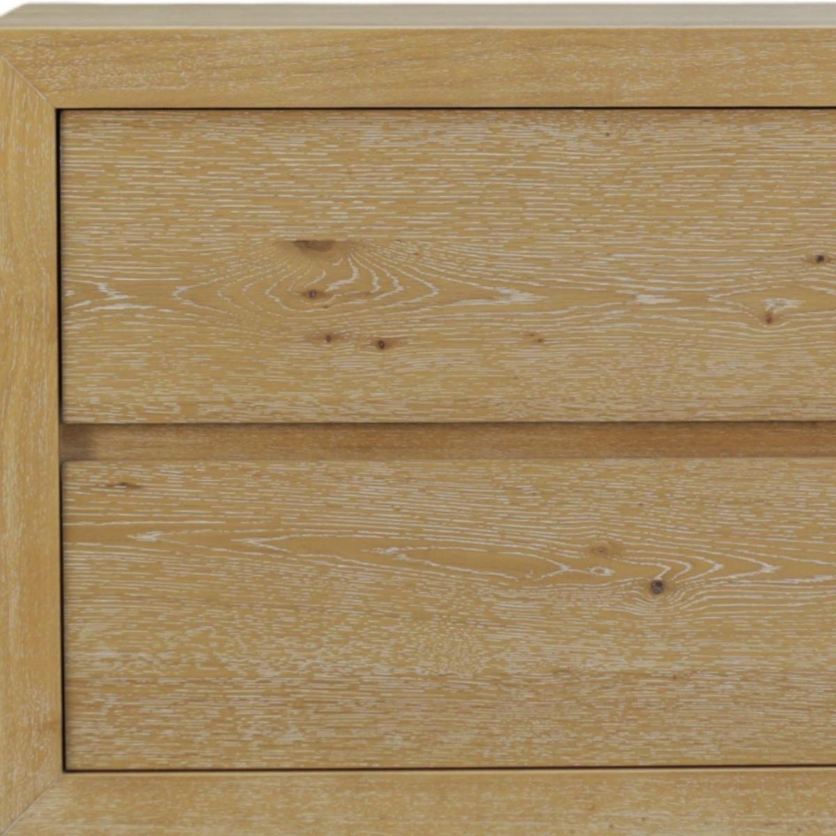 Oak wood nightstand drawer front close-up with visible grain and recessed panel