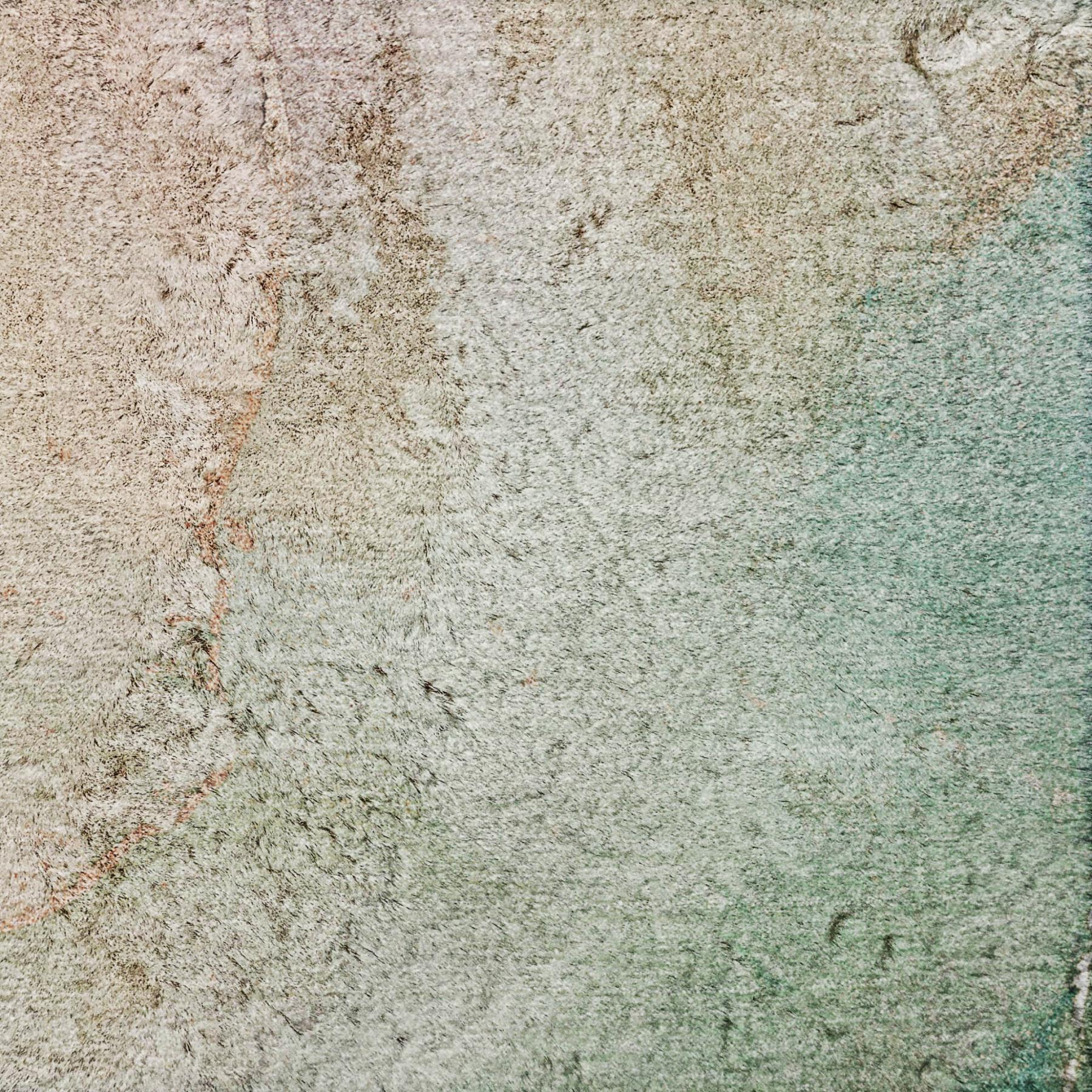 Abstract shag area rug with teal, green, and beige fibers