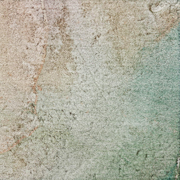 Abstract shag area rug with teal, green, and beige fibers