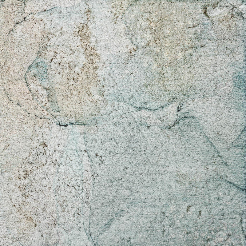Abstract shag area rug close-up in light gray with teal accents and marbled texture