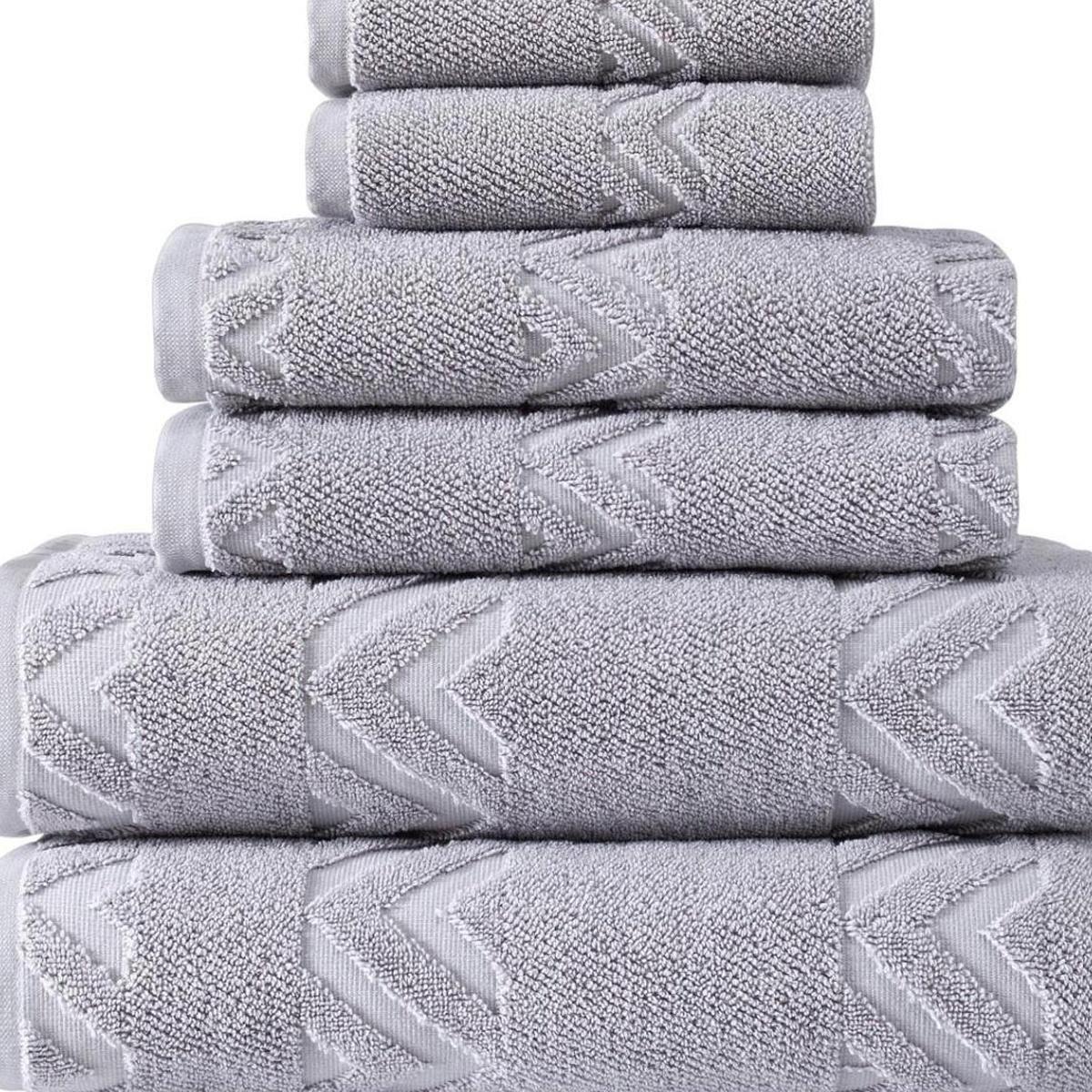 Stack of light gray Turkish cotton towels with raised chevron pattern