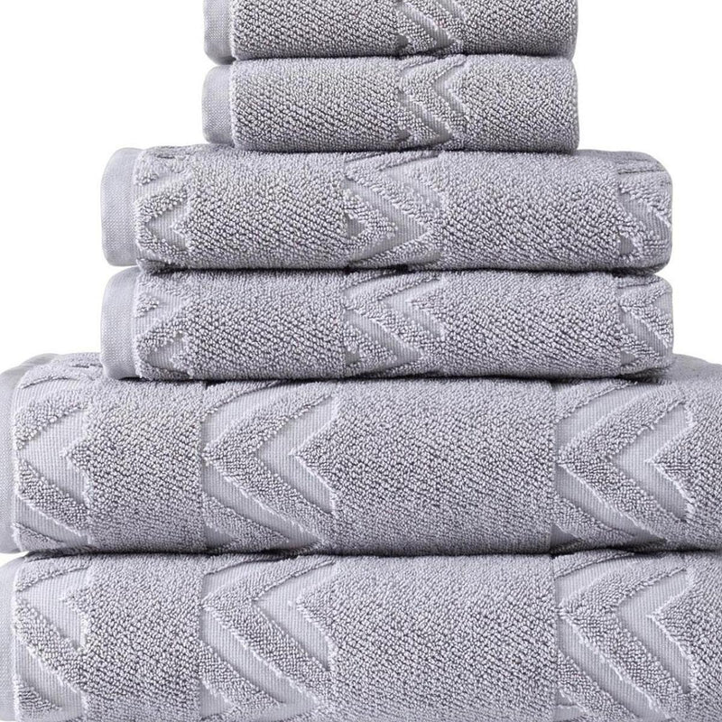 Stack of light gray Turkish cotton towels with raised chevron pattern