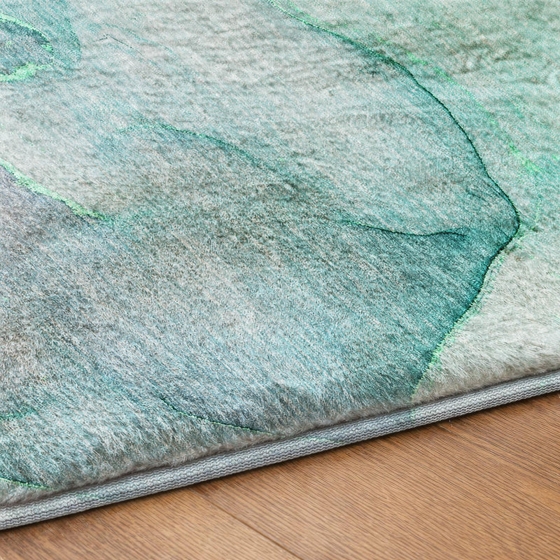 Washable shag area rug corner with abstract teal-green streaks and gray border