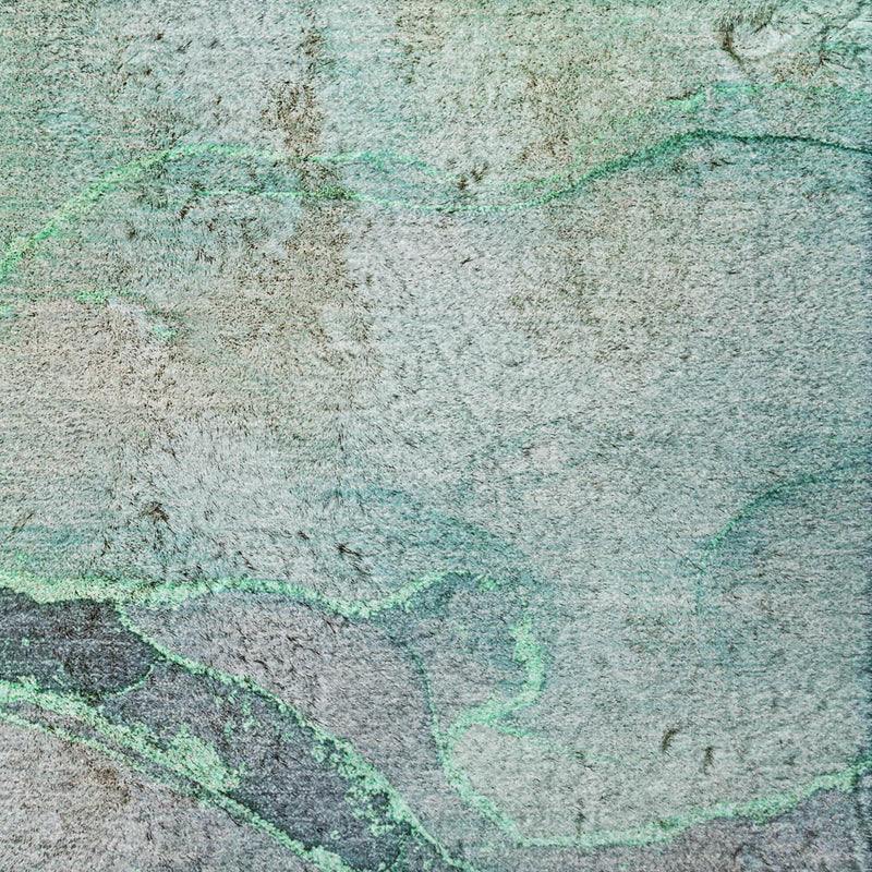 Green and teal abstract shag rug surface with textured fibers and marbled pattern